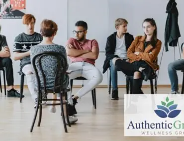 An adult woman counseling a group of teenagers.