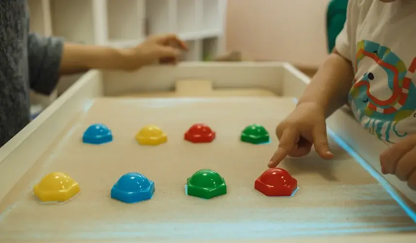Children painting in the interactive sand box , sand animation