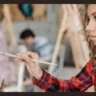 Child expressing emotions by painting during an art therapy session, showcasing the benefits of art therapy for emotional expression and healing.