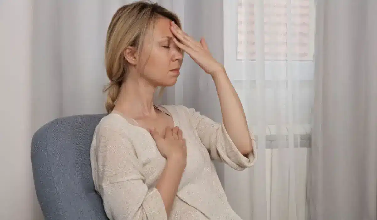 Client practicing grounding technique during EMDR therapy for emotional regulation in trauma counseling session.