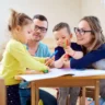 Parents and children engaging in a playful activity at home, illustrating a positive and supportive approach to child therapy.