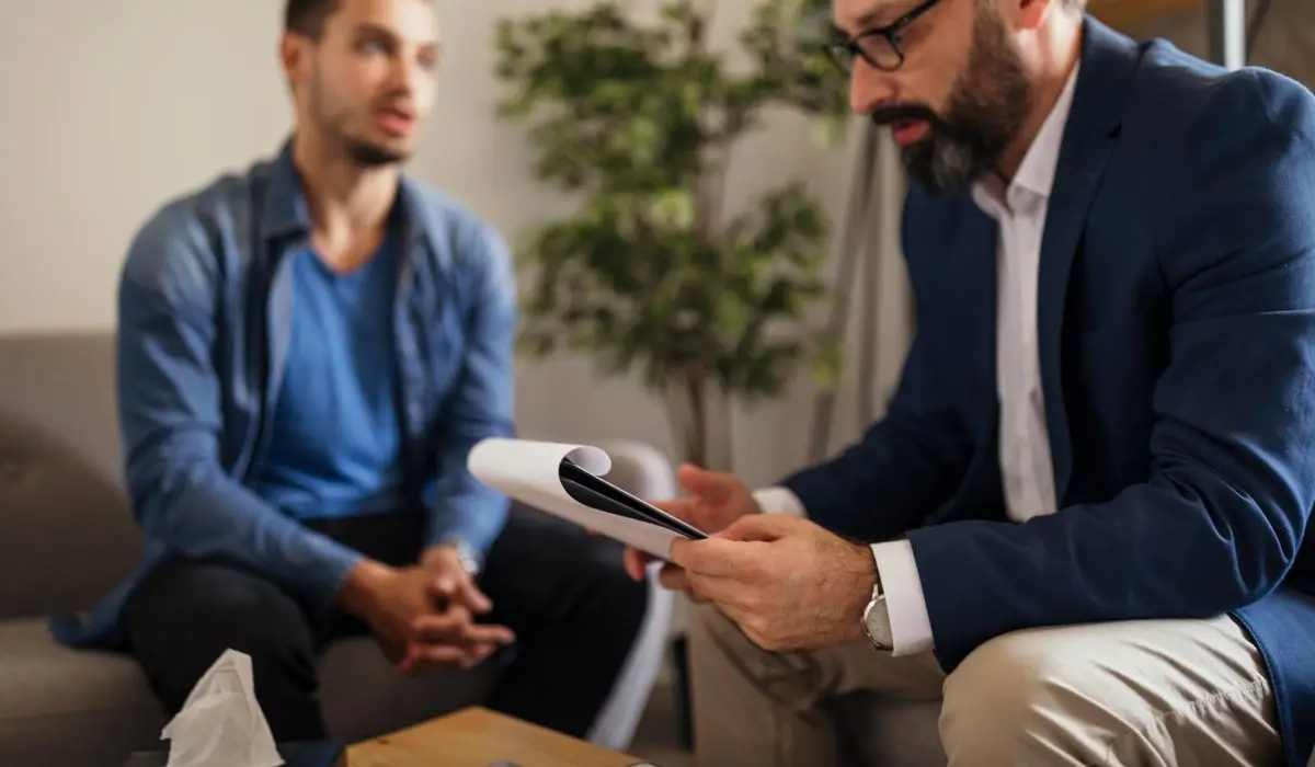 Therapist discussing treatment plan with client during counseling to address hidden PTSD symptoms effectively.